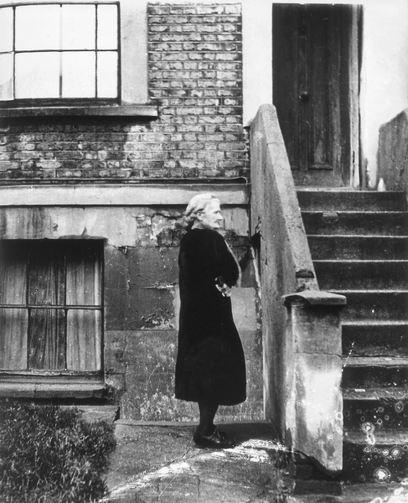 Old woman in front of her house, Bethnal Green